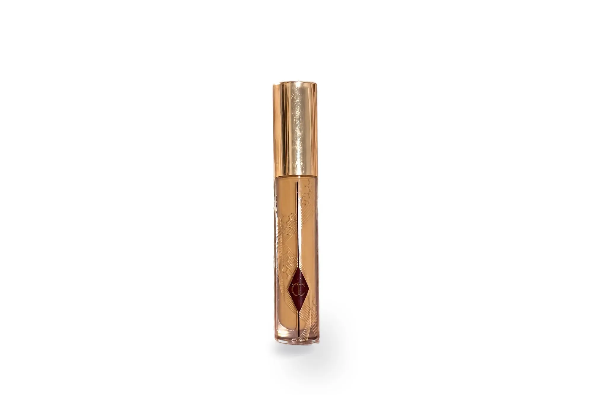 Charlotte Tilbury concealer with a gold cap on a white background